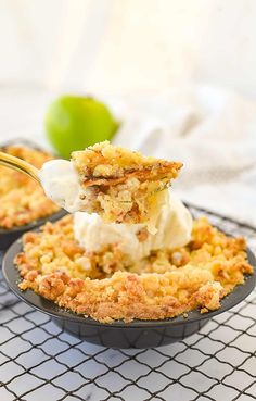 a spoonful of ice cream is being lifted from a pie in a black dish