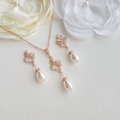 An Elegant Jewelry Set for Brides and Bridesmaids Made with Teardrop Pearls & Rose Gold in Vintage-Inspired Design A beautiful pearl jewelry set is for brides and bridesmaids in rose gold is made with a vintage-inspired design with teardrop pearls. The set combines a pair of earrings and a matching necklace. The Pearl pendant and earrings set is combined with sparkly, swirly leaf-shaped decorative cubic zirconia and Swarovski pearls. The pearl drop on both pendants and earrings are wire drop Feminine Rose Gold Pearl Necklace For Wedding, Rose Gold Pearl Drop Necklace For Wedding, Pearl Pendant Set, Bridal Jewelry Pearl Sets, Pearl Jewelry Set, Beautiful Bridal Jewelry, Rose Gold Pearl, Pearl Bridal Jewelry, Bridal Jewelry Set