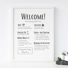 a white framed poster with the words welcome on it next to a black and white present box