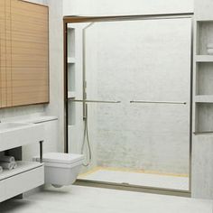 a bathroom with a sink, toilet and shower stall in the middle of the room