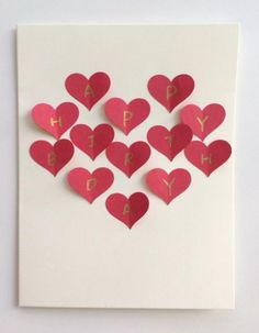 heart shaped paper cut out into the shape of letters and numbers on a white card