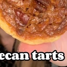 a person holding up a piece of food with the words vegan tarts on it