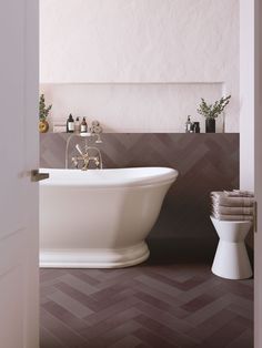 a white bath tub sitting next to a toilet