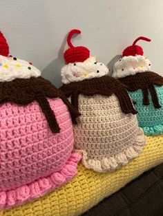 three crocheted ice cream sundaes sitting on top of each other