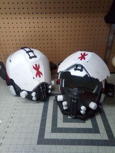 two white helmets with red crosses on them