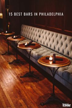 three tables with candles on them are lined up against a bench in a room that has wood flooring