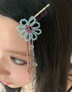 a close up of a person wearing a head piece with beads and chains on it