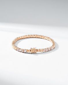 Crafted in 18-karat gold, this tennis bracelet incorporates our beloved baguette diamonds unevenly set while interchanging them with sections of gold all the way around. We love this piece for its seamless design and everyday wearability. The perfect baguette tennis bracelet to instantly elevate any outfit, casual or formal. Details 18k yellow gold, rose gold or white gold 2.00 carats of white diamond baguettes Bracelet measures 7" inches in length Box clasp with safety lock fastening 5mm width Rose Gold Baguette Cut Tennis Bracelet For Formal Occasions, Formal Rose Gold Baguette Cut Tennis Bracelet, Baguette Cut Diamond Bracelets, Luxury Baguette Tennis Bracelet For Anniversary, Fine Jewelry Rose Gold Diamond Bracelet With Baguette Cut, Rose Gold Baguette Cut Diamond Bracelet, Elegant Rose Gold Baguette Diamond Tennis Bracelet, Elegant Gold Diamond Bracelet With Emerald Cut, Luxury Rose Gold Baguette Cut Bracelets