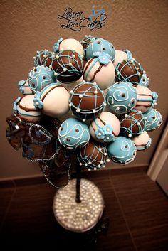 a vase filled with blue and white decorated chocolates