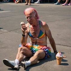 an older man sitting on the ground eating ice cream