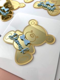 some gold and blue stickers on top of a white envelope