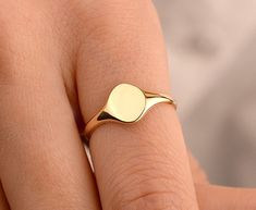 Our circle disc ring is made of 14k solid gold. It fits your all outfit at any time of the day with its minimalist and dainty style. Also, it can be used as a joint ring. You can enter the name, initial, date, or whatever you want on the personalization box. Your name is engraved with a special laser. ( You can see the example of a ring that is engraved with a special laser in the photos.) If you consider it as a gift for special days, it will a perfect choice for your loved ones on their birthd Modern Adjustable Signet Ring, Dainty Adjustable Signet Ring, Formal Stackable Signet Ring, Tarnish Resistant Round Yellow Gold Midi Rings, Tarnish Resistant Yellow Gold Round Midi Rings, Adjustable Minimalist Rounded Jewelry, Round Band Jewelry With Smooth Finish As Gift, Round Band Jewelry With Smooth Finish For Gift, 14k Gold Signet Ring With Smooth Bezel As Gift