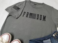 Freedom shirt, proudly added an American flag. This super soft tshirt is pressed HTV of customers choice.   This is a perfect tshirt to wear on any occasion! Paired with your favorite scarf, hat and sweater. Too cute to pass up.  FIT: True to size, Unisex Please contact me if you have any questions. I am happy to answer all of them I am looking forward to pressing for you! This tshirt is made to order  Wash the tshirt inside out cold water, do not bleach DO NOT IRON DIRECTLY ON THE DESIGN!  DO NOT DRY CLEAN  other items in photo NOT included Freedom Shirts, Fun Shirt, Scarf Hat, Flag Tshirt, Fourth Of July, Cool Shirts, American Flag, Cold Water, Inside Out