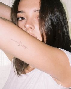 a woman with a tattoo on her arm