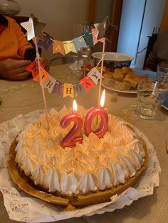 a birthday cake with candles on it sitting on a table