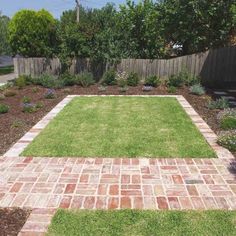 a brick walkway in the middle of a yard