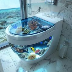 a toilet with an aquarium on the side in a bathroom next to a glass door