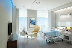 a hospital room with a bed, desk and chair