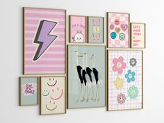 there are many framed pictures on the wall with pink and blue accents, including an electric bolt