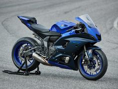 a blue motorcycle parked on top of a race track