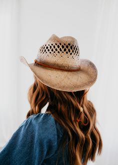 As a product made from 100% straw raffia, the Karter Cowboy Hat offers natural, breathable material for comfortable wear. With an elastic sweatband and leather chin cord, this one-size-fits-most hat stays secure and in place. The tea stains add a touch of rustic charm to this classic accessory. Brim: 3.5" 100% Straw Natural Woven Hat Bands For Rodeo, Rustic Adjustable Panama Hat For Rodeo, Natural Woven Hats For Ranch, Brown Toquilla Straw Hat For The Ranch, Brown Straw Fedora For Ranch, Brown Toquilla Straw Hat For Ranch, Adjustable Western Style Natural Panama Hat, Country Style Adjustable Fit Straw Hat With Short Brim, Woven Natural Hats For Ranch