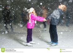 two young children playing in the snow