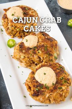 crab cakes with cauliflower sauce on a white plate next to some green peppers