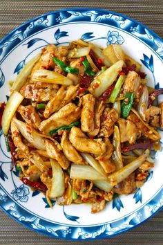 chicken stir fry on a blue and white plate with the words five spice chicken stir fry