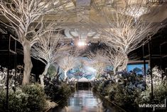 the inside of a building with trees and plants