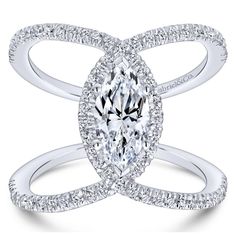 a white gold ring with an oval cut diamond in the center