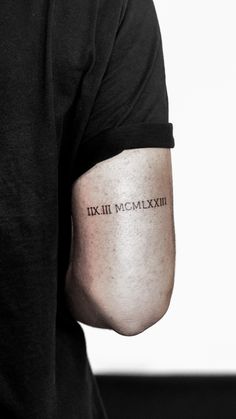 a man with a tattoo on his arm that says xxii mcmexxiii