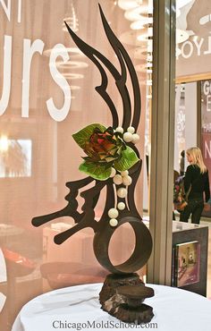 a decorative item is displayed in front of a store window