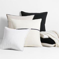 pillows and blankets on a white surface