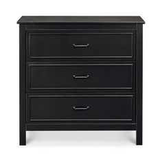 a black night stand with three drawers and two pulls on the bottom drawer, in front of