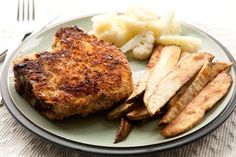 a plate with some meat and potatoes on it