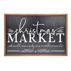 a christmas market sign hanging on the wall in front of a white background and wooden frame