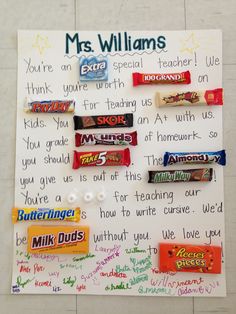 a bulletin board with candy bars and writing on it