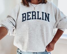 ✨Basic Info✨ This listing is for a sweatshirt that says 'BERLIN' on the front! The color of the sweatshirt is 'Ash', but contact me if you would like to see a different color! I also offer sweatshirts with other cities, but let me know if there is a city you don't see that you would like me to make! Make sure you check out our other great products like our Potions Collection T-Shirts :) ✨Shirt and Sizing Info✨ All VillainessLabs crewneck sweatshirts are printed on a Gildan 18000 Unisex Heavy Ble Sweat Vintage, Football Sweatshirt, Colorado Rockies, Look Vintage, Carolina Panthers, North Dakota, Denver Colorado, Knit Set, Lacrosse