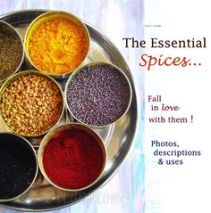 six bowls filled with different types of spices on a metal tray, sitting on top of a wooden table