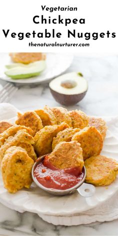 chicken nuggets on a plate with ketchup and an avocado