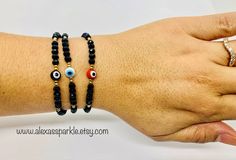 The post is for one individual bracelet. This beautifully handmade bracelet is made of 4mm black rondelle crystal beads, small gold beads with a turkish glass eye bead that is 6mm. They are made with red nylon string and are adjustable to fit most wrists as it has a sliding knot to adjust. These are a great accessory for everyday wear. This bracelet is great for spiritual and evil eye purposes. It is believed that when a person wears or carries an evil eye with them, it guards against misfortune Black Evil Eye Round Beads Jewelry, Black Beaded Bracelet With Evil Eye, Black Evil Eye Bracelet With Round Beads, Black Beaded Evil Eye Bracelet With Round Beads, Black Evil Eye Bracelet With Round Beads As Gift, Black Adjustable Rondelle Beaded Bracelets, Protection Bracelet, Sliding Knot, Glass Eyes