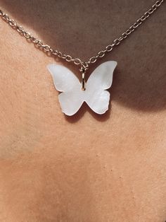 This necklace is a perfect match to the Cassandra Pearlized Butterfly Earrings. The way they glimmer in the sunlight gives an almost ethereal effect. In many places around the globe, butterflies represent resurrection, endurance, change, hope, and life. Available Colors: Angelic White, Pearl Blossom, and Sea Glow Size: 16 in. chain with extender | Acrylic Pendent Charm Holder, Sterling Necklaces, Hand Of Fatima, White Butterfly, Butterfly Necklace, Butterfly Earrings, White Pearl, Pink Tourmaline, Sterling Silver Necklaces