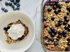 blueberry baked oatmeal in a casserole dish next to a bowl of yogurt