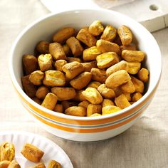 a bowl filled with fried food next to a plate