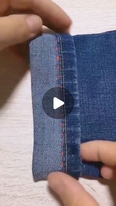 someone is stitching the side of a pair of jeans