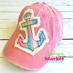 a pink hat with an anchor embroidered on it