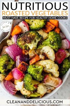 a white bowl filled with roasted vegetables and broccoli on top of a table