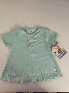 0-3 Month Infant girls top Small 23  inches to 11 lbs. 100 % Cotton Exclusive of decoration. Ruffle sleeves and on the  bottom on shirt.  Round neck, Two bees, Five flowers with two bees on the top part of shirt. Bottom has ruffle with flowers and bees also. Still has the tags. Blue Cotton T-shirt With Ruffles, Green Crew Neck Top With Ruffles, Green T-shirt For Spring Playtime, Cute Flutter Sleeve Tops For Spring, Crew Neck Shirt With Ruffles For Spring, Fitted T-shirt For Spring, Fitted Cotton Top With Flutter Sleeves, Fitted Cotton Tops With Flutter Sleeve, Casual Fitted Tops For Playtime