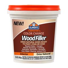 a bucket of color change wood filler on a white background with an orange lid