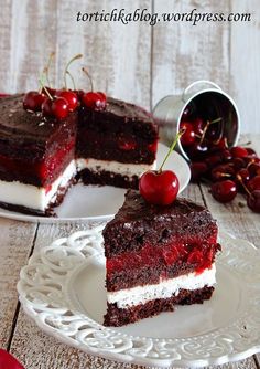 two pieces of cake on plates with cherries